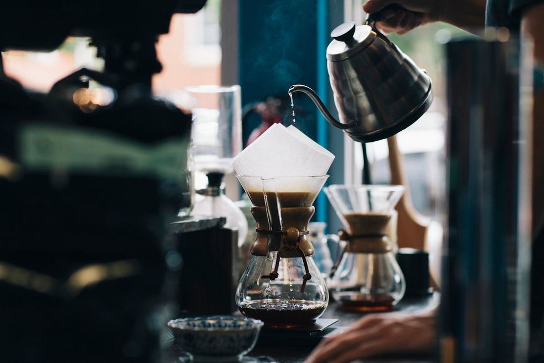 A warm cup of coffee held in hand, highlighting the rich colour and inviting aroma of freshly brewed specialty coffee
