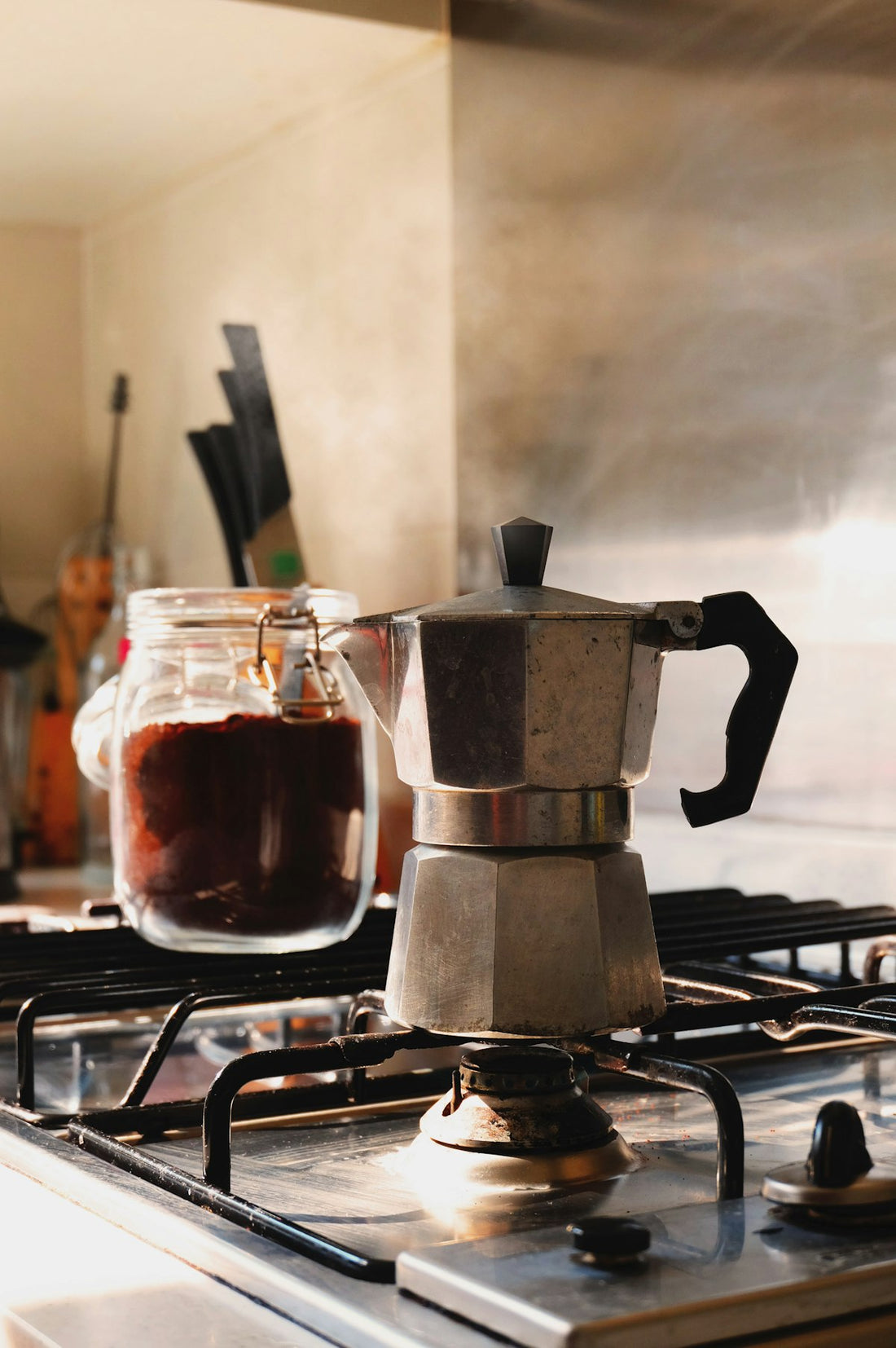 Moka pot brewing espresso-style coffee on a gas stovetop