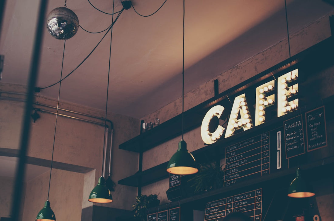 Inside a busy specialty coffee shop with barista preparing drinks behind the counter