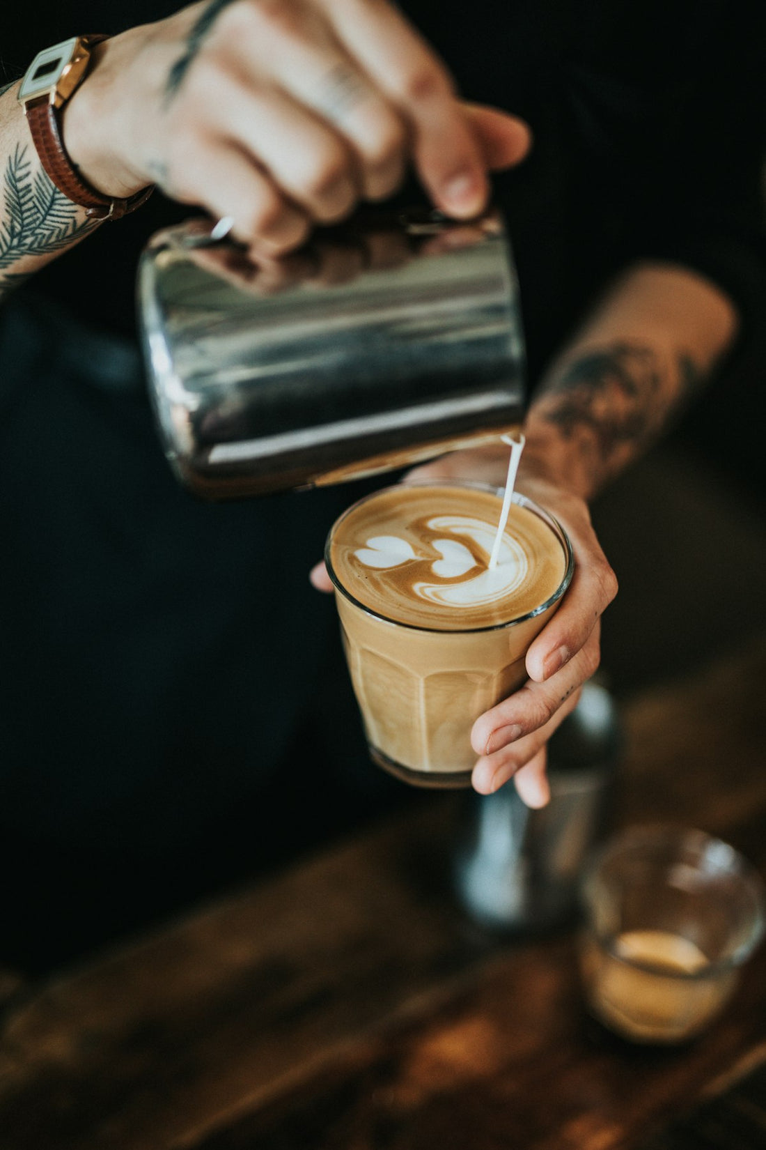 A cup of black coffee on a dark surface with natural light