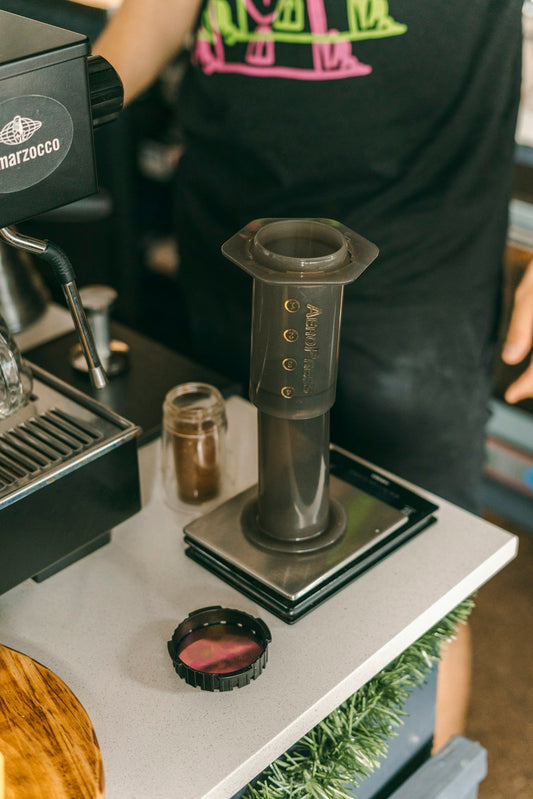 AeroPress coffee maker on a table ready for brewing specialty coffee