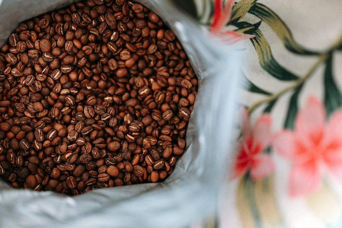 Close-up of freshly roasted coffee beans in a kraft paper bag