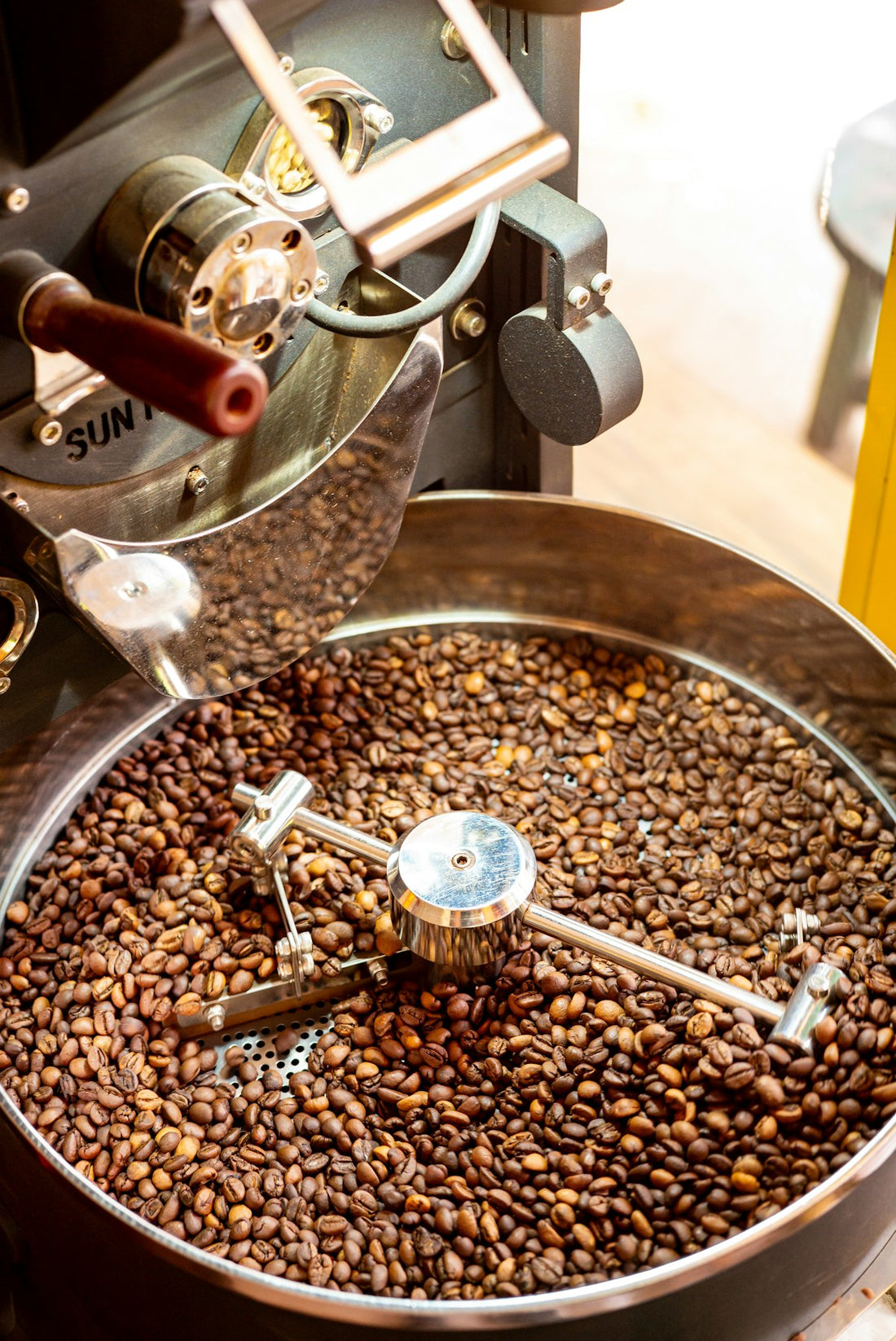 Freshly roasted specialty coffee beans cooling in a roaster drum